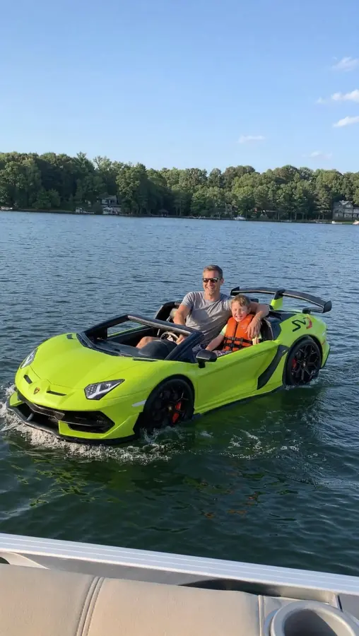 Father and son riding the green DriftFloat Lamborghini SVJ together on a lake