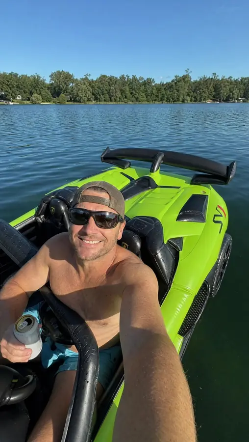 Customer selfie cruising the DriftFloat Lamborghini SVJ on a calm lake