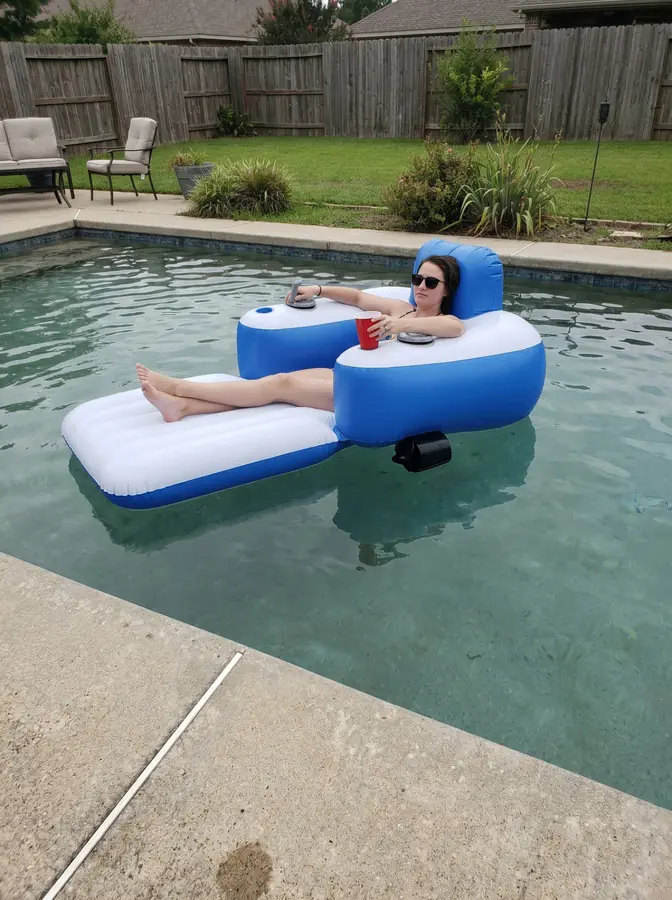 Customer relaxing on the JetStream Lounger X2 in her backyard pool