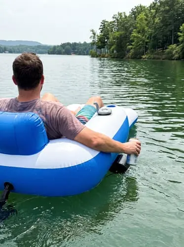 Rider steering the JetStream Lounger X2 across a calm lake
